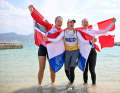 Here, Ilca 6 Olympic champion Marit Bouwmeester, Denmark's silver medallist Anne-Marie Rindom and Line Flem Høst from Norway celebrate their medals together