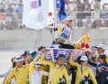 Here, Olympic champion Matt Wearn is carried high up on his Ilca 7 by his team from Down Under
