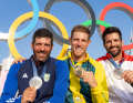 The Olympic Ilca 7 podium with two-time Olympic champion Matt Wearn, silver medallist Pavlos Kontides and Stefano Peschiera from Peru