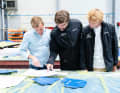 Here, the three companions are immersed in their plans.