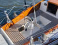 Angular: Tiny wheel in a narrow cockpit. The design language and ergonomics originate from wooden boat building.