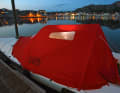 Blue hour under a red dome tent. If required, the Lite XP offers dry seating in the cockpit and a double berth in the foredeck.