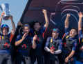 From America's Cup novice to Louis Vuitton Cup winner: Olympic 49er champion and Moth World Champion Dylan Fletcher with the trophy and his jubilant crew