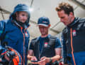Sir Ben Ainslie (r.) and his team at a meeting