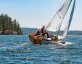 The small boat is characterised by a positive natural wood stern, the clear lacquered coaming and strong lines