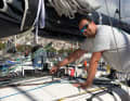 Le co-skipper Cord Hall travaille sur le bateau avant le départ.