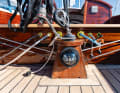Here the traveller is also a halyard scow. The lines run through the ship and exit at the riding beam. They are operated with constrictor clamps