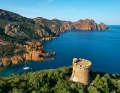 Anchorage amidst the rocky backdrop of Marina d'Elbo. High above the bay is an old Genoese tower that was once intended to protect the island from pirates