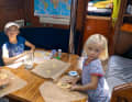 Rolling out dough and cutting out biscuits - most children love baking, and the girls on the "Lady Blue" do too