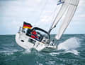 Tighten the sails up to the upwind position. Above all, crank the genoa tightly, the better it will back afterwards