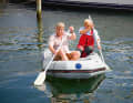 If the dinghy is too small for this, the only option is to paddle sitting on the tube