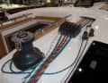 Arranged. Halyards and trim lines are attached to the "pianos" on the companionway to the