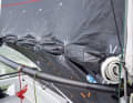The mainsail is cut as low as possible to avoid wind turbulence over the deck - technically known as a "deck sweeper". The main boom is a wishbone bracket that is only guided on one side