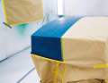 1. primed. The paper catches the spray mist, a film underneath prevents the paint from penetrating