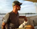 The skipper with the new co-sailor: the cat "Half Die"