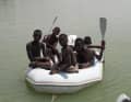 Village children board the dinghy