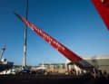 The wing of the 72-foot catamaran is put in place