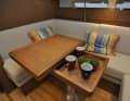 The bright seating area to starboard with a multifunctional and lowerable table.