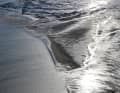 Shining mudflats: light effects on a unique amphibious landscape create a bizarrely beautiful picture