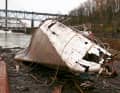 After the salvage operation, the hull of the once proud twelve-person vessel lies on land like a beached whale