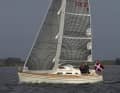 The 335 also has a narrow and efficient sail plan. However, it sails more stiffly due to the greater draught and more ballast