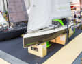 It stands on the Bente stand next to the model made of conventional boat building materials