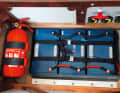 A must
At least one good fire extinguisher, preferably one in each compartment, should be on board
