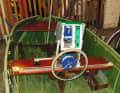 Above the steering wheel is a bulky box with a voltage converter. The skipper inserts a tablet for navigation into the box