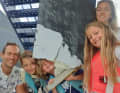 The Erichsen family with the broken rudder of their sailing yacht