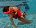 The buoyancy distribution is designed to ensure that the adult and infant adopt a stable and safe swimming position.