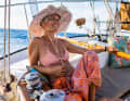 Relaxed on board. Collinson at the tiller of her ship on the way to Panama