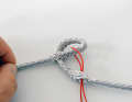 ... then thread a thin pilot line and use it to pull the eye through the opening. This twists the short part, ...