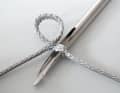 To make it easier to pull the eye through the short part for the second crossing, widen the stitch with a thick fid ...