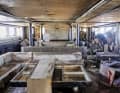 The interior, designed by Remi Tessier, is completely destroyed, with mud and dirt in every corner, as here in the salon.