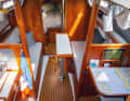 Heavily modified: The saloon is designed for two people. But you can still sleep there: your feet will be under the galley or the navigation table