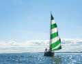 The foresail blows out. The green and white striped genoa has become a trademark.