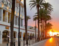 The sun bathes the promenade of Puerto de la Savina on Formentera in orange-red light