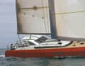Cigale 15 QR with many sporty features. Short, flat cabin superstructure, chamfers at the transition from hull to deck, long bowsprit.