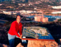 Prince Karim Aga Khan in 1960 on a hill above Porto Cervo, with the Yacht Club Costa Smeralda, which he co-founded, in the background.
