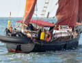 Red sails over a black hull are reminiscent of a workboat. The centreboards provide buoyancy, the internal ballast stability
