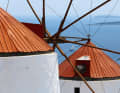 White windmills in front of a blue sea: pure Greece.