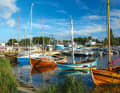 In a small harbour on the Hel peninsula, pretty old wooden boats with clinkered hulls are moored in front of the reeds