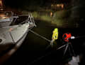 Control round: On the jetty in waders, aft with the trainer boat: lines are checked and adjusted