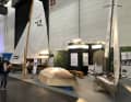 The stand at boot Düsseldorf with the TH OWL's wooden skiff in the background, the new project and the "Förderacer", a similar project by shipbuilding students from Kiel