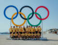 The national sailing team and their coaches at the five Olympic XL rings on the beach in Marseille
