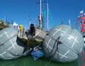 The manufacturer demonstrates the use of the lifting bags on a monohull.