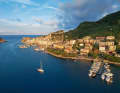A magical atmosphere over Porto Venere. The mild light of the evening sun illuminates the houses in the old town centre