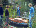Grebe's wife and three sons inspect the 1:10 scale model