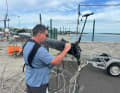 Daniel Schaade works on the mast of Lennart Burke and Melwin Fink's Class40.