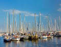 Lying in a packet is common in many places during the high season. There are also other ways to get a place in a crowded harbour
